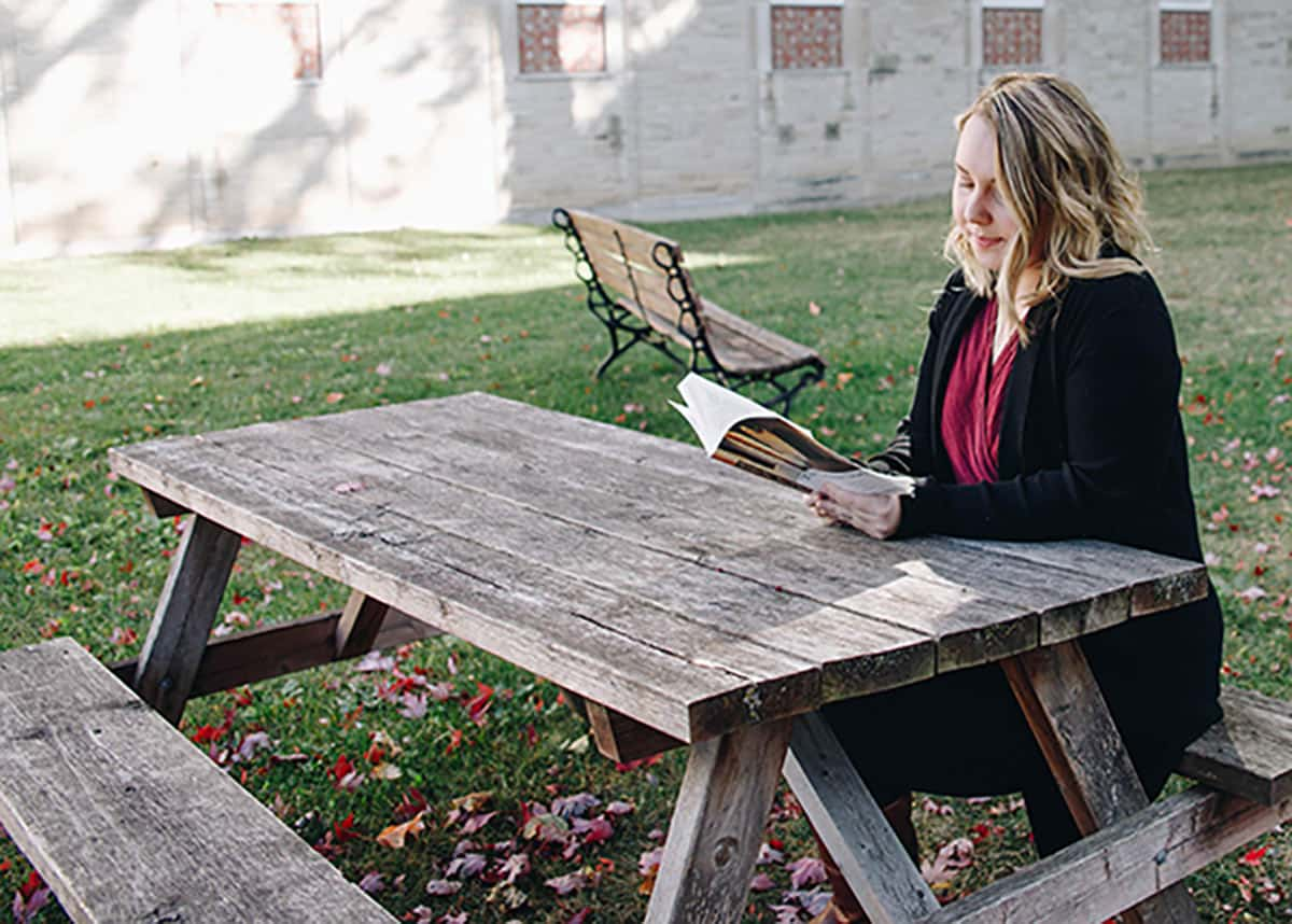 Student reading outside of Tyndale Campus