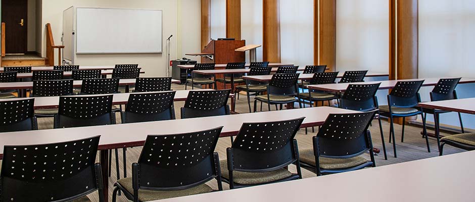 An empty classroom with chairs and tables