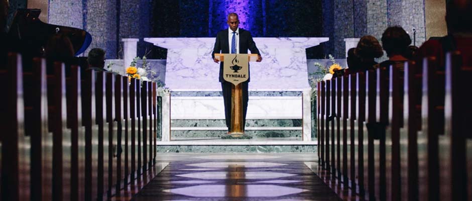 A male pastor preaching at the pulpit