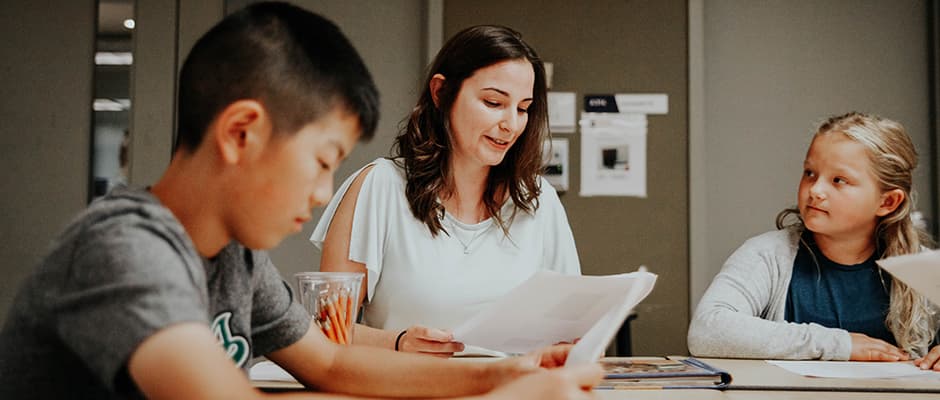 Teacher candidate and students reading