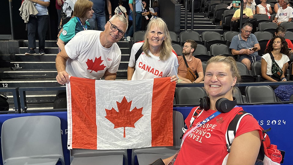 Nikita with her parents at the Paris Olympics in 2024