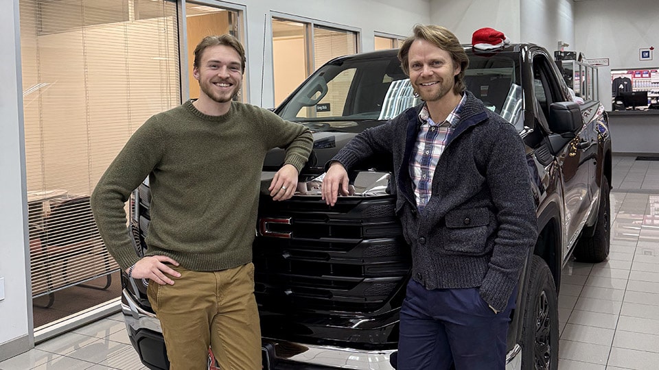 Matt Habinski standing infront of a pickup truck