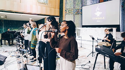 University students singing and playing instruments during a chapel service