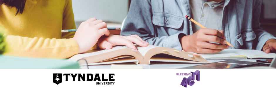 two people studying with an open book in front of them on the table