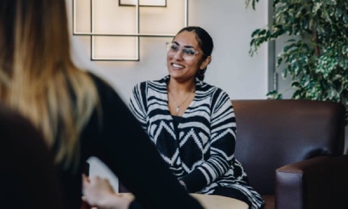 two female adults chatting in a relaxed setting