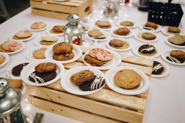 Plates full of holiday cookies and biscuits on a large table