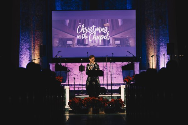 Christmas in the Chapel featuring President Marjory Kerr at the podium at Tyndale University chapel