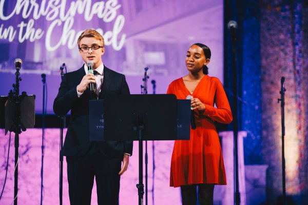 Male and female Tyndale Students speaking at podium at Tyndale University chapel