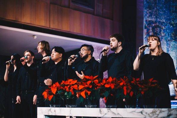 A group of young adults singing dressed in black