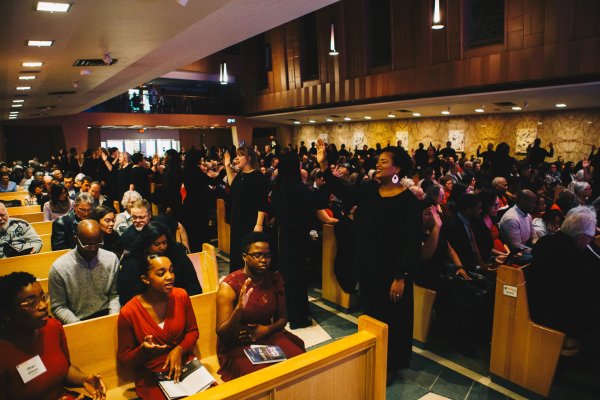 Congregation singing in their pews in the Tyndale University chapel