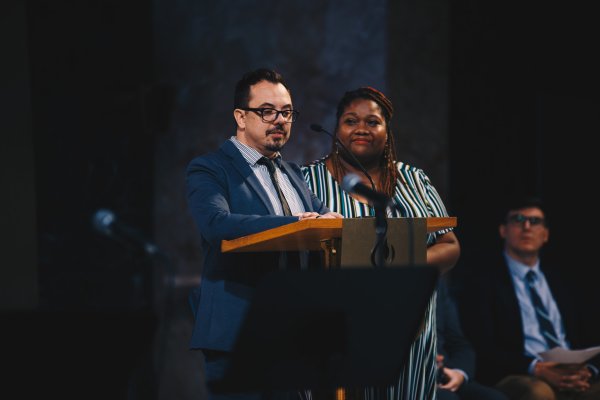 Man and women speaks at podium, Michael and Felicia Fischhoff gives speech