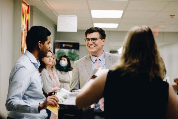 Academic Dean Dr. W. Paul Franks smiling and greeted by Tyndale Spring in the Chapel volunteers