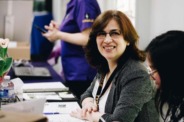 Women smiling at the Spring in the Chapel ticketing booth