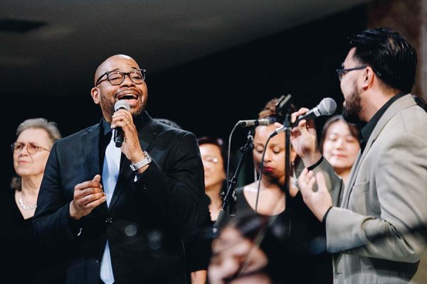 Saj McKenley sings and harmonizes alongside Tyndale student at centre stage of the chapel