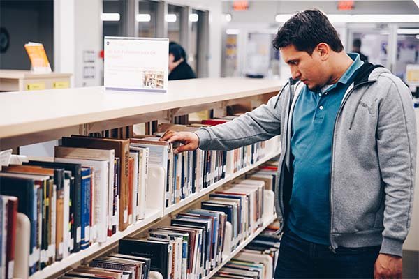 Student looking for books in the library