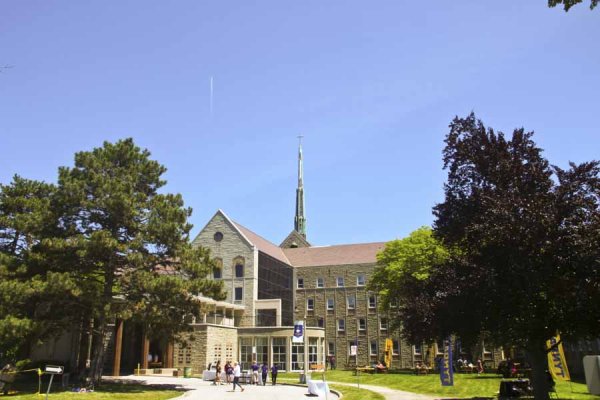 Front of the Tyndale campus with people mingling