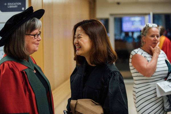 Graduate parent talking with faculty