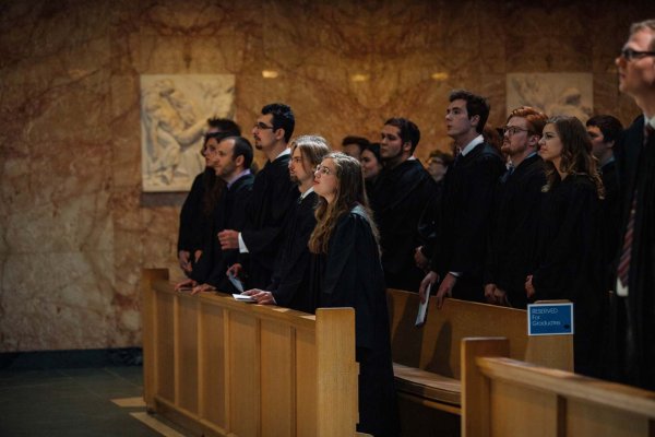 Graduates standing up in the chapel