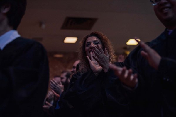 Graduates standing up in the chapel