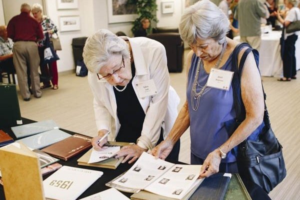 alumni looking at yearbooks