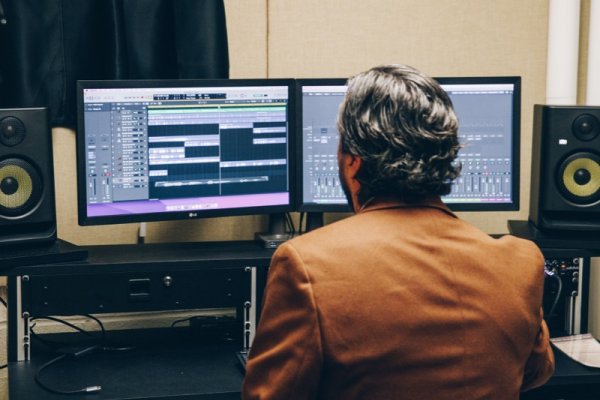 Faculty in front of recording equipment