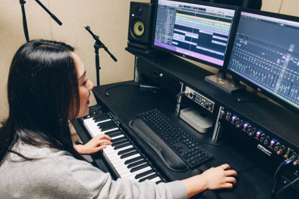 Student using keyboard and recording equipment in the MaTH