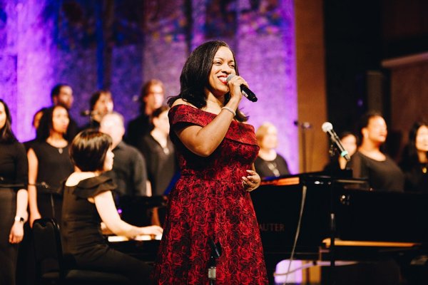 Dr. Melissa Davis singing on stage with the Tyndale Community Choir